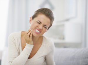 portrait of young woman with toothache Bruxism dentist in Towson Maryland